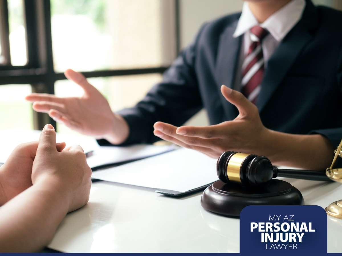 
A lawyer gesturing while discussing with a client, possibly about a rear-end car crash case, with a gavel indicating a legal setting