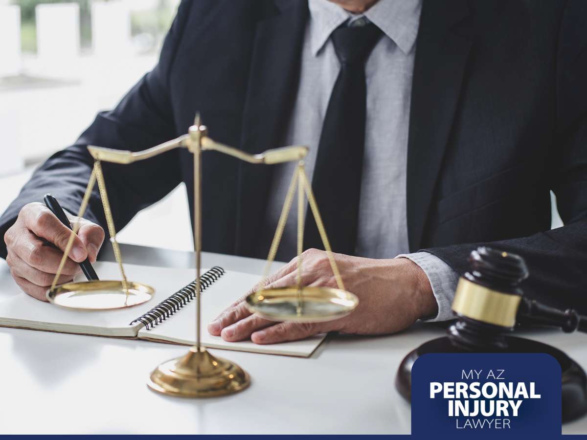  A personal injury lawyer at a desk with a pen in hand, scales of justice, a notebook, and a gavel, related to cases involving rental cars.