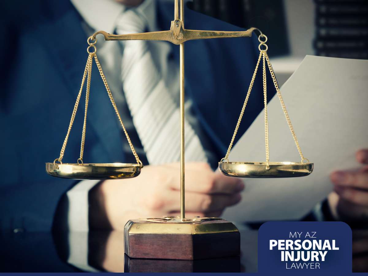 Scales of justice in focus with a blurred lawyer in the background, symbolizing legal help for those injured by a drunk driver